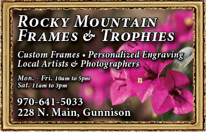 A sign advertising Rocky Mountain Frames & Trophies, with a picture of a pink flower. AI generated content